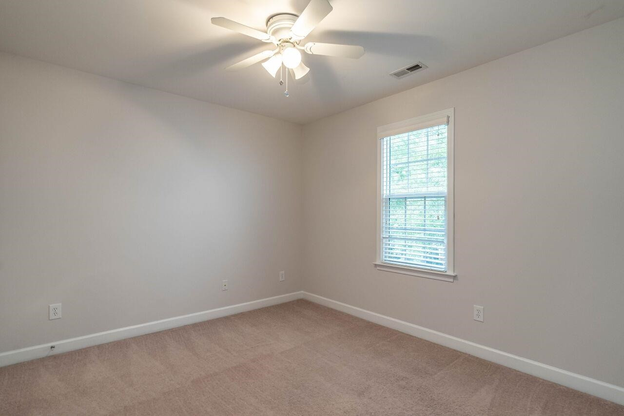 5948 Kohler Lane Raleigh, NC 27616 - Photo 25 of 32 an empty room with a window and a fan