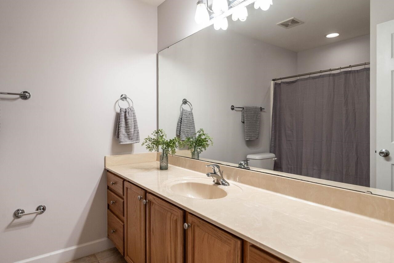 5948 Kohler Lane Raleigh, NC 27616 - Photo 26 of 32 a bathroom with a sink and a mirror