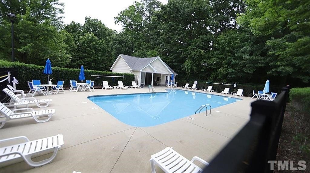 5948 Kohler Lane Raleigh, NC 27616 - Photo 32 of 32 a view of swimming pool with outdoor seating and plants
