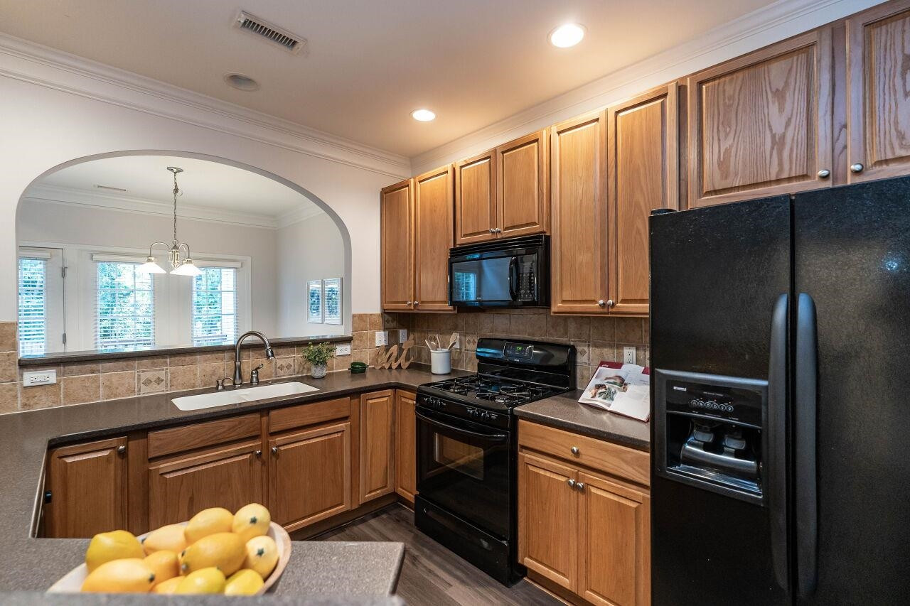 5948 Kohler Lane Raleigh, NC 27616 - Photo 7 of 32 a kitchen with granite countertop a refrigerator stove top oven and sink