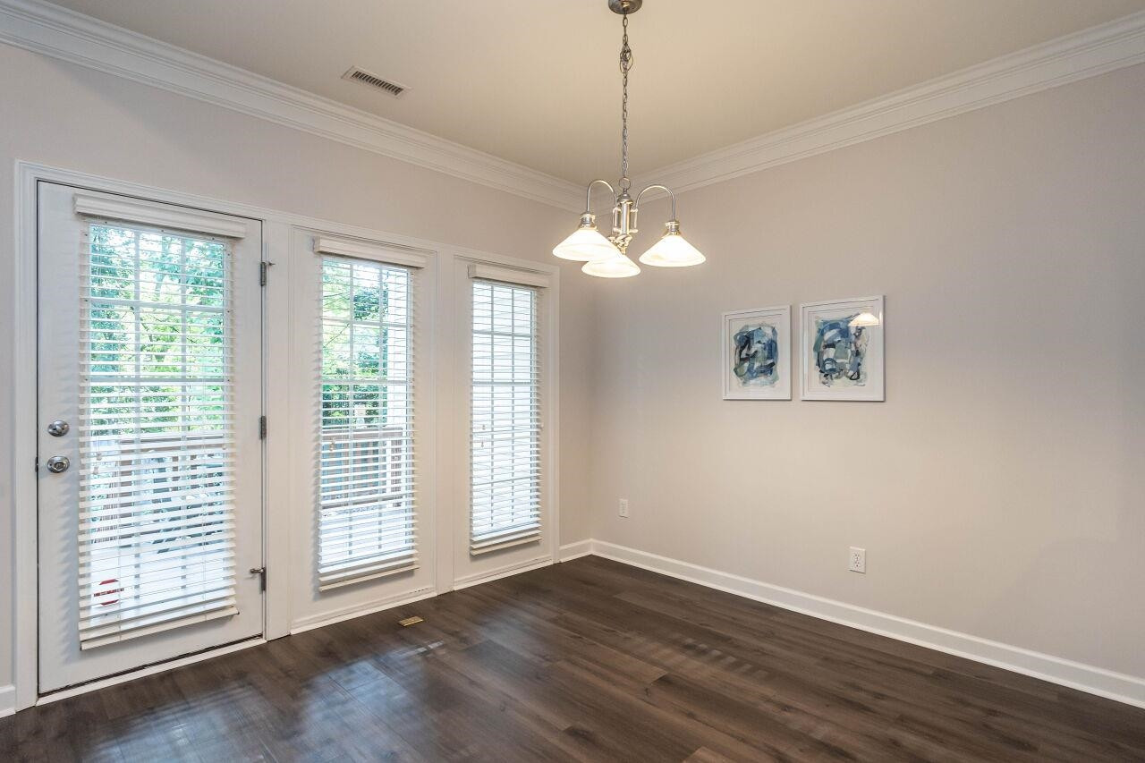 5948 Kohler Lane Raleigh, NC 27616 - Photo 10 of 32 a view of an empty room with a window and wooden floor