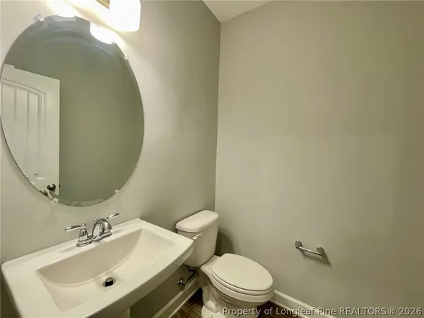 a bathroom with a sink mirror and toilet