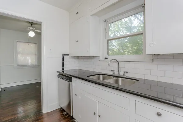 a kitchen with granite countertop a sink and a window