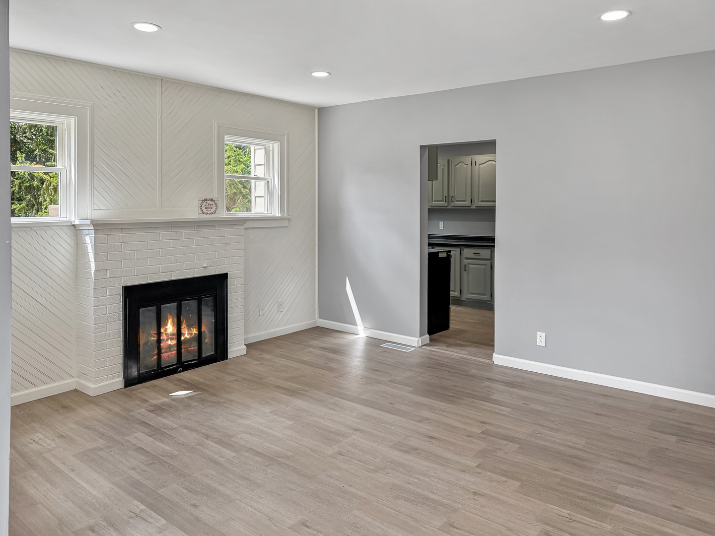 302 West Cook Street Sheffield, IL 61361 - Photo 5 of 18 a view of an empty room with a fireplace and a window