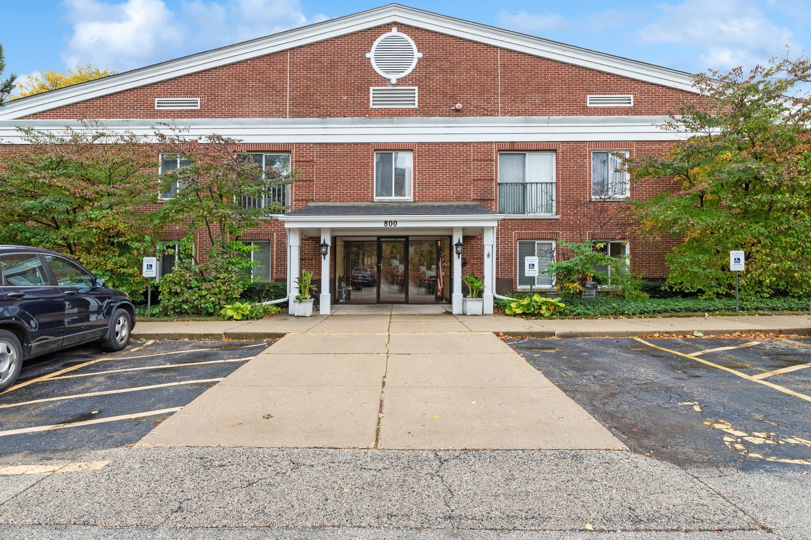 800 Ridge Road, Unit 103 Wilmette, IL 60091 - Photo 3 of 12 a front view of a building with garden