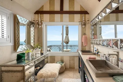 a dining hall with stainless steel appliances a table and chairs