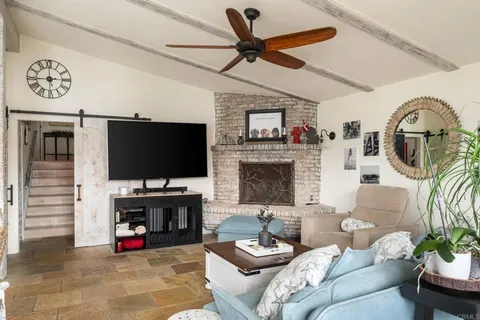 a roof deck with table and chairs potted plants and a large tree