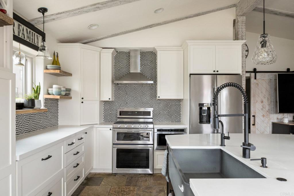 200 Neptune Avenue Encinitas, CA 92024 - Photo 32 of 33 a kitchen with stainless steel appliances a sink a stove and cabinets