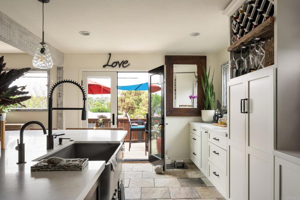 200 Neptune Avenue Encinitas, CA 92024 - Photo 33 of 33 a kitchen with stainless steel appliances granite countertop a sink and a refrigerator