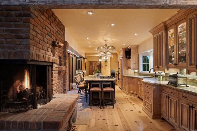 a view of a patio with a table and chairs under an umbrella
