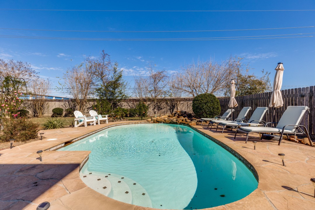 16902 Colony Creek Drive Spring, TX 77379 - Photo 8 of 18 a view of a swimming pool with a yard and sitting area