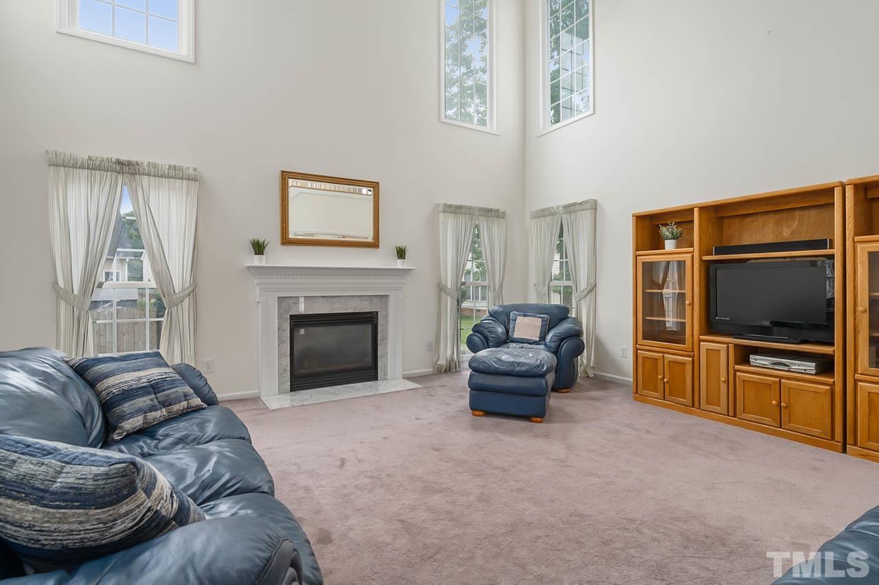 5906 Big Nance Drive Raleigh, NC 27616 - Photo 11 of 40 a living room with furniture and a flat screen tv