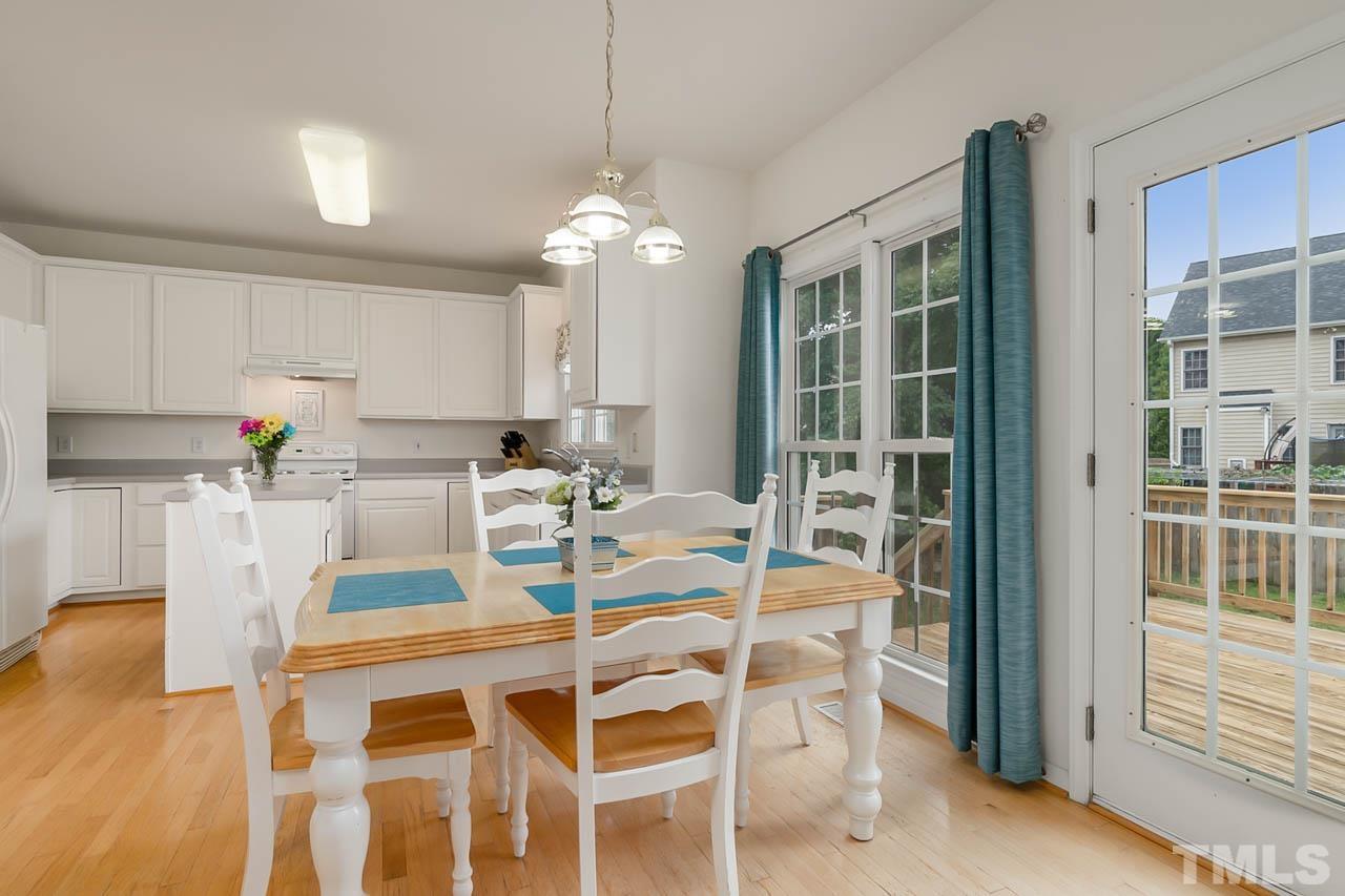 5906 Big Nance Drive Raleigh, NC 27616 - Photo 14 of 40 a view of a dining room with furniture wooden floor and chandelier