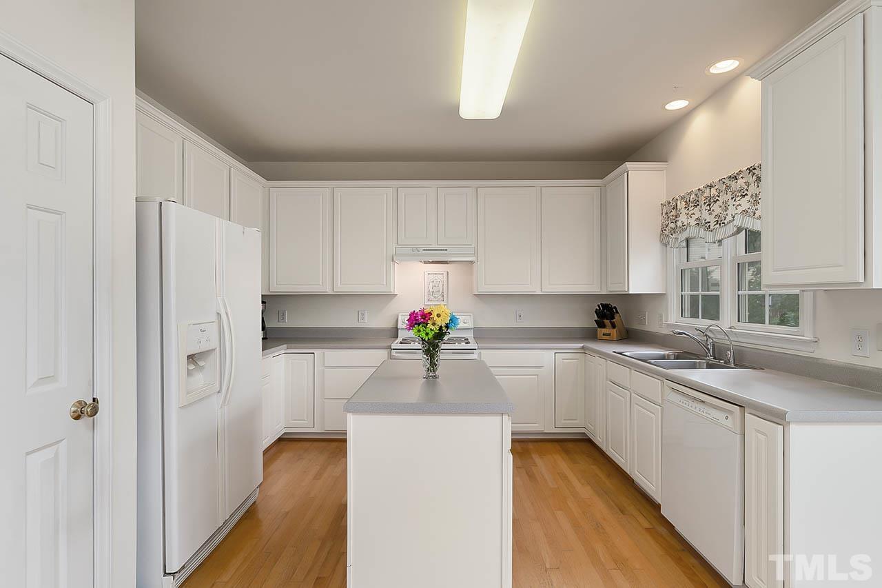 5906 Big Nance Drive Raleigh, NC 27616 - Photo 16 of 40 a kitchen with a sink stove and refrigerator