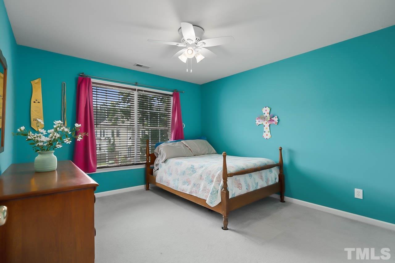 5906 Big Nance Drive Raleigh, NC 27616 - Photo 20 of 40 a bed sitting in a bedroom next to a window