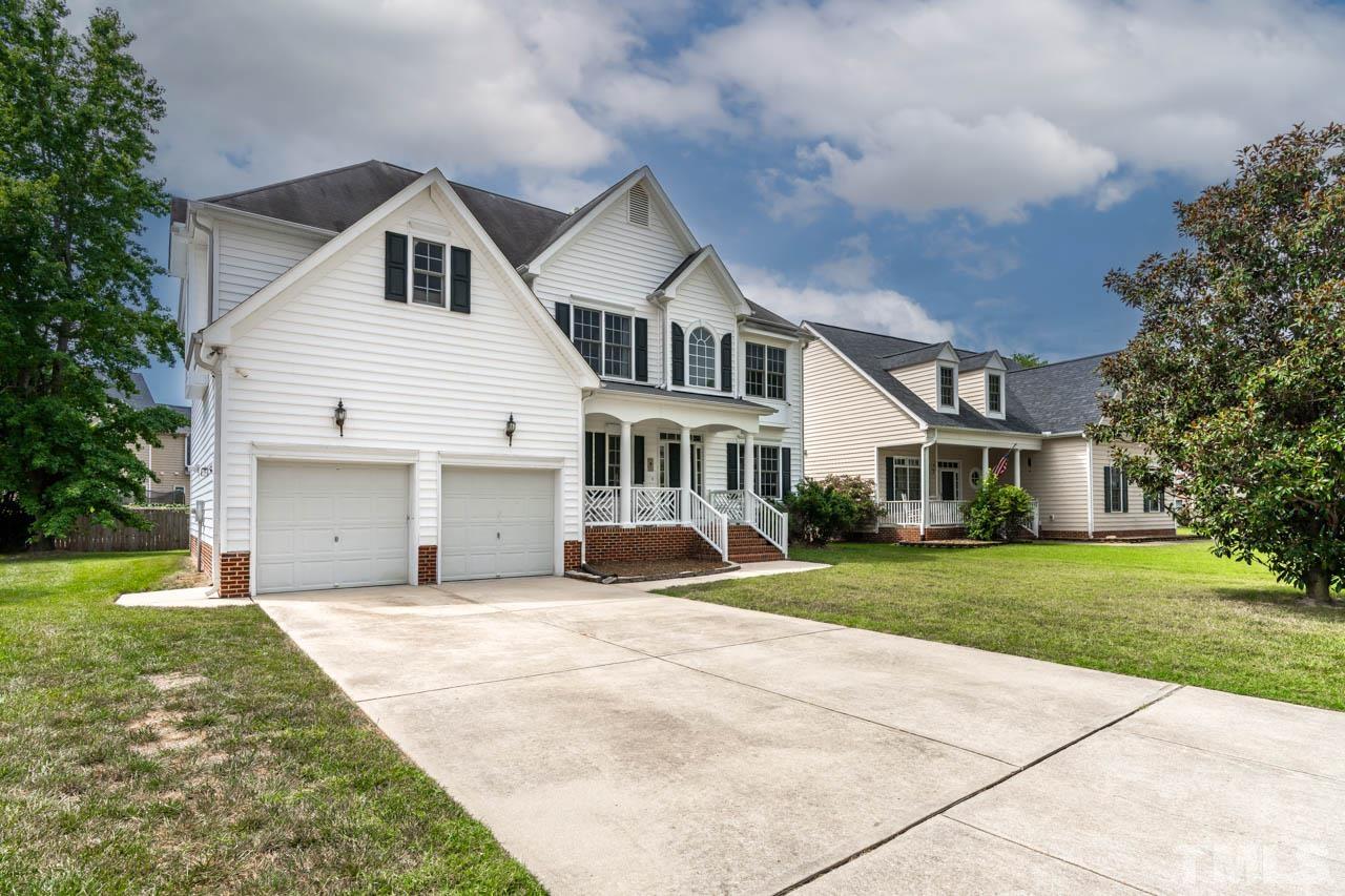 5906 Big Nance Drive Raleigh, NC 27616 - Photo 2 of 40 a front view of a house with a garden and trees