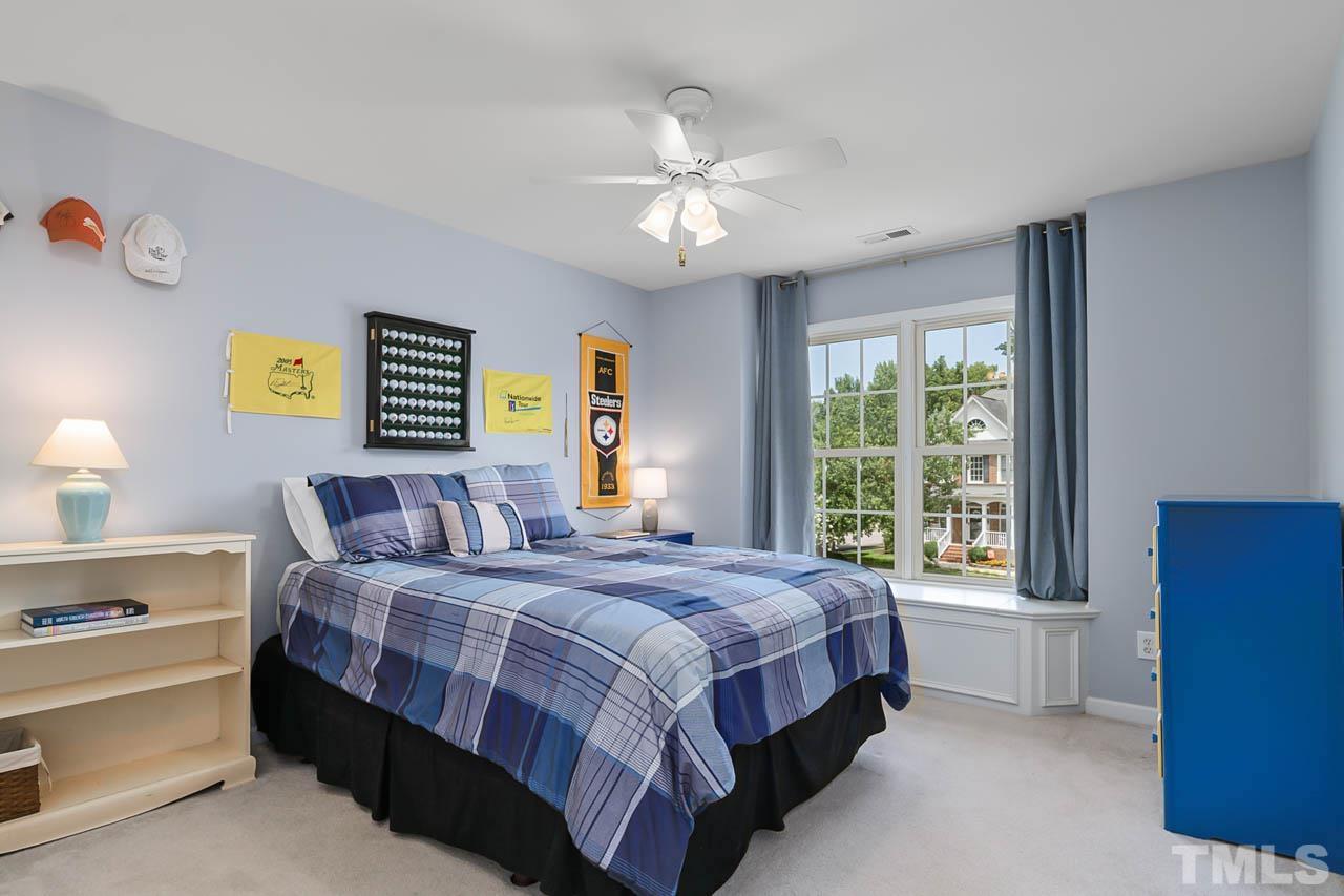5906 Big Nance Drive Raleigh, NC 27616 - Photo 21 of 40 a bedroom with a bed and a window