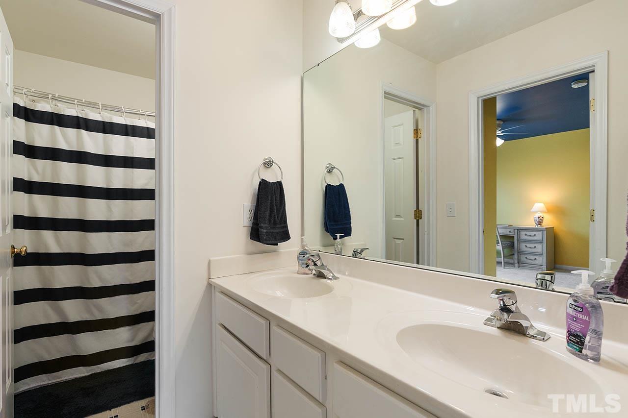 5906 Big Nance Drive Raleigh, NC 27616 - Photo 23 of 40 a bathroom with a sink and a mirror