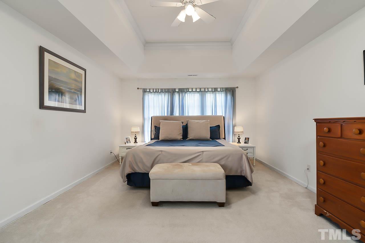 5906 Big Nance Drive Raleigh, NC 27616 - Photo 26 of 40 a bed room with a bed and a chandelier