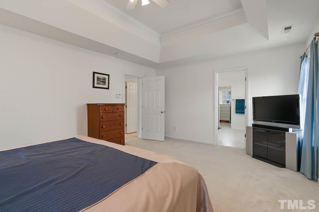 5906 Big Nance Drive Raleigh, NC 27616 - Photo 27 of 40 a bedroom with a bed and a television in it