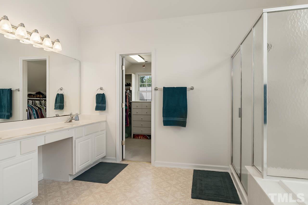 5906 Big Nance Drive Raleigh, NC 27616 - Photo 28 of 40 a spacious bathroom with a shower and a sink