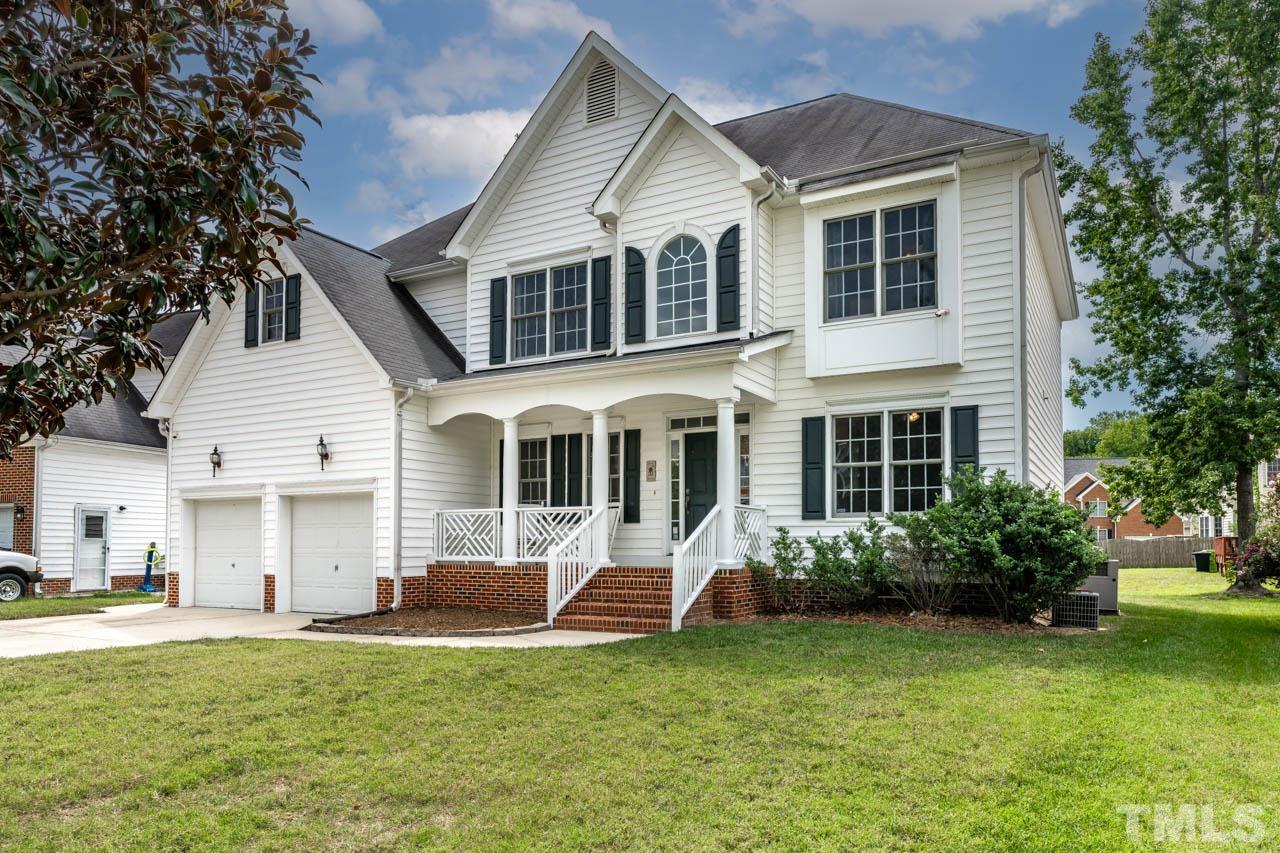 5906 Big Nance Drive Raleigh, NC 27616 - Photo 3 of 40 a front view of a house with a garden and porch