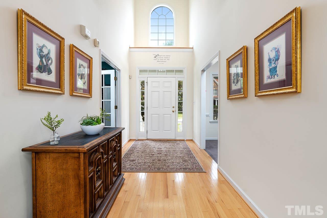 5906 Big Nance Drive Raleigh, NC 27616 - Photo 5 of 40 a hallway with painting on the wall and a large window