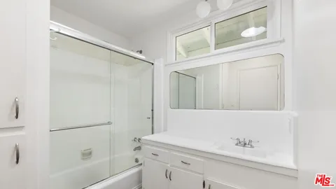 a bathroom with a bathtub and a shower