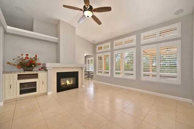 a view of an empty room with a fireplace and a window