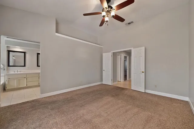a view of an empty room with a cabinet and a window