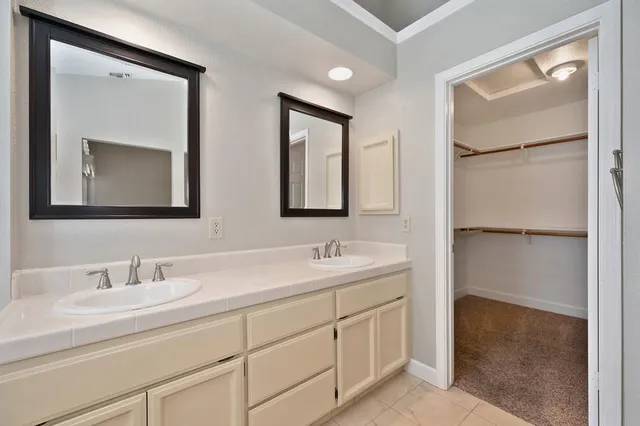 a bathroom with 2 sink and a mirror