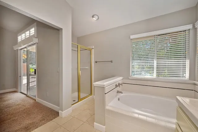 a bathroom with a bathtub and a shower