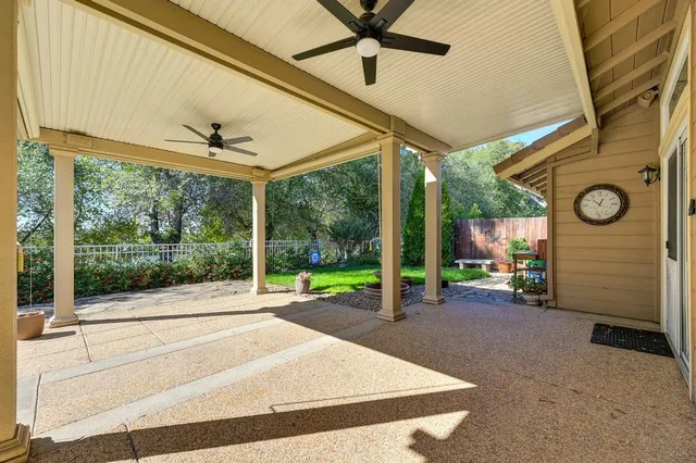 a view of a patio with a table and chairs