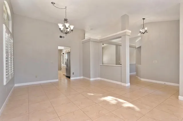 a view of a chandelier fan and refrigerator in a kitchen