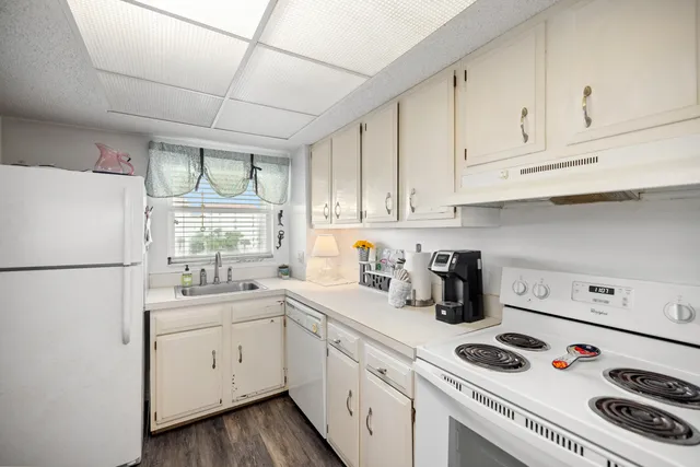 a kitchen with a white cabinets sink and white appliances