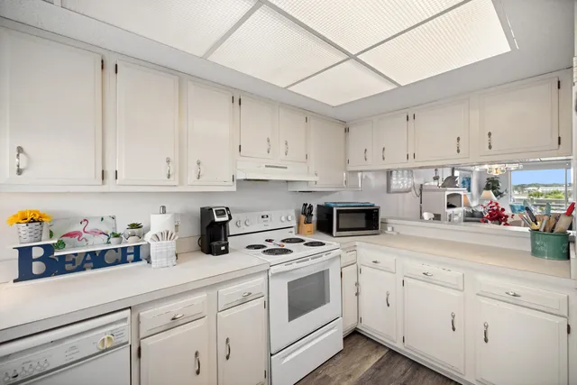 a kitchen with cabinets appliances a sink and a counter top