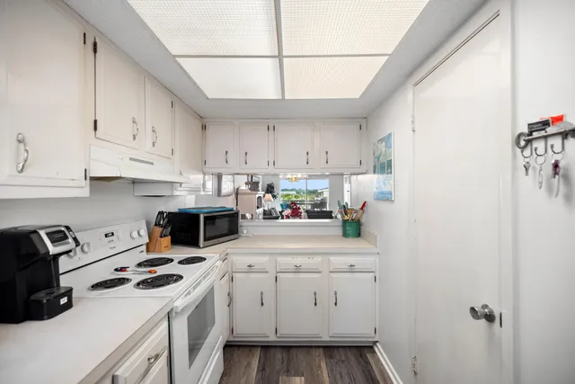 a utility room with cabinets washer and dryer