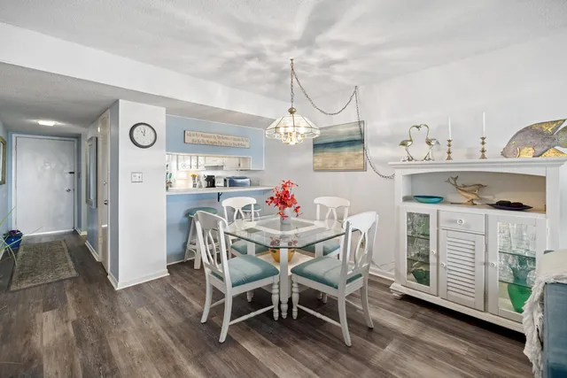 a view of a dining room with furniture wooden floor and a chandelier