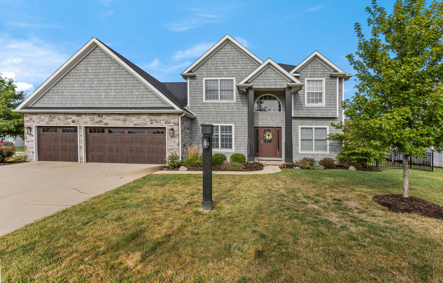 1621 English Oak Drive Champaign, IL 61822 - Photo 1 of 62 a front view of a house with a yard and garage