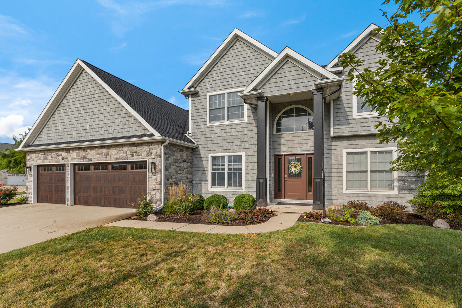 1621 English Oak Drive Champaign, IL 61822 - Photo 3 of 62 a front view of a house with a yard and garage