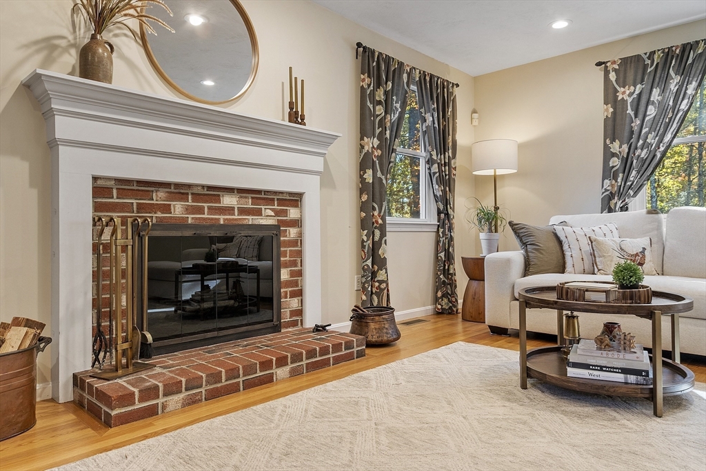 4 Celestial Way Pepperell, MA 01463 - Photo 19 of 41 a living room with furniture a fireplace and a table