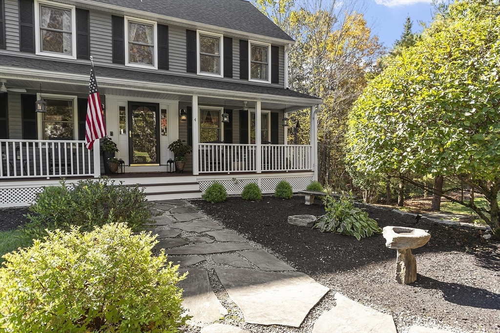 4 Celestial Way Pepperell, MA 01463 - Photo 2 of 41 a front view of a house with a yard and garden