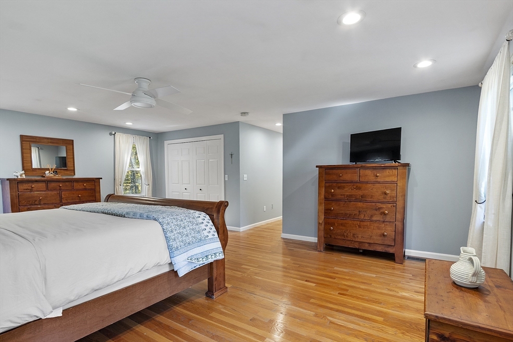 4 Celestial Way Pepperell, MA 01463 - Photo 24 of 41 a bedroom with a bed and a flat screen tv