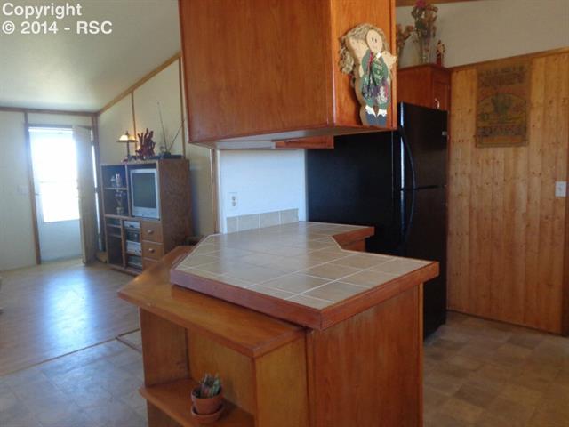 4665 North Log Road Peyton, CO 80831 - Photo 13 of 13 This rancher features an open-concept floorplan. Perfect for entertaining.