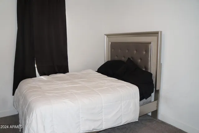 a bedroom with a bed and a mirror