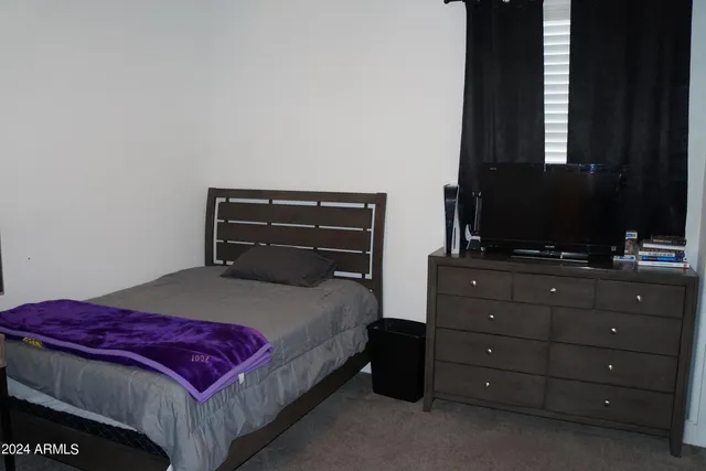 a bedroom with a bed and a mirror