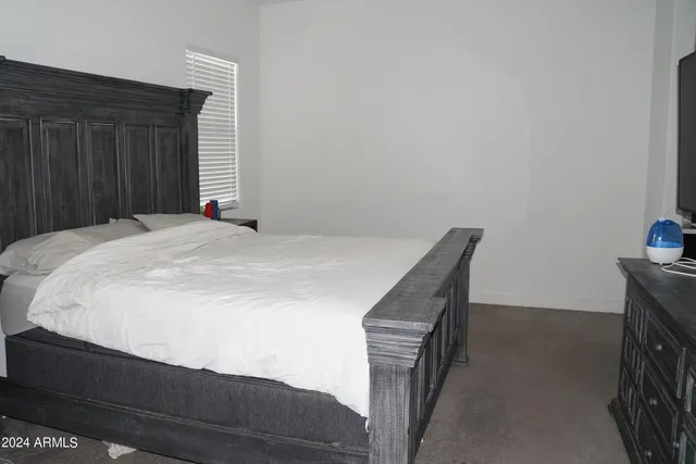 a bedroom with a bed and a tv