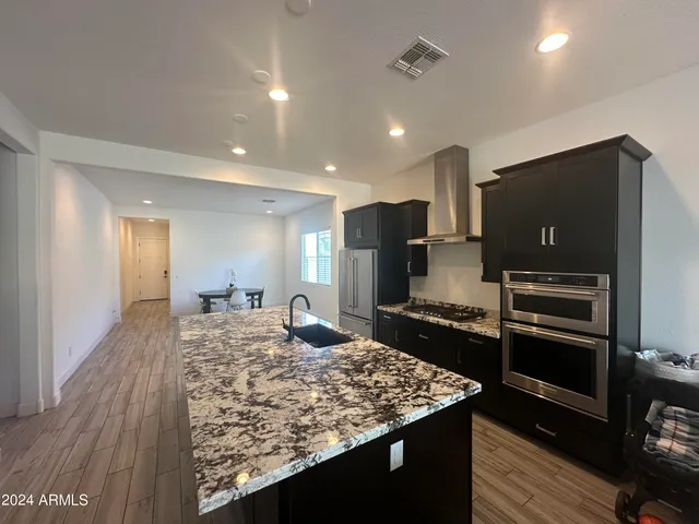 a kitchen with a center island and stainless steel appliances
