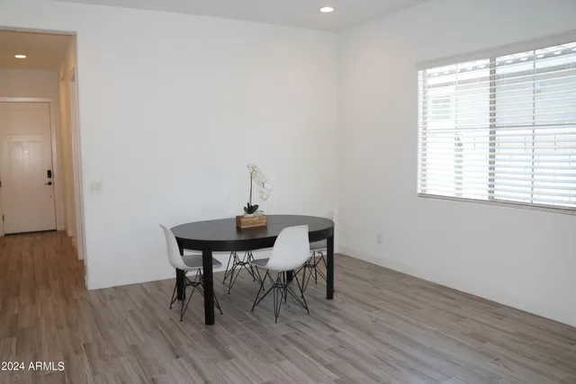 a view of a room with a table and chairs