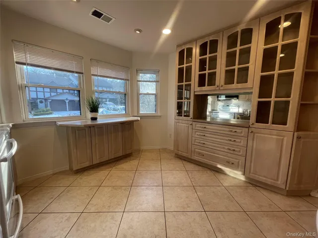 a kitchen with a refrigerator a stove top oven and cabinets